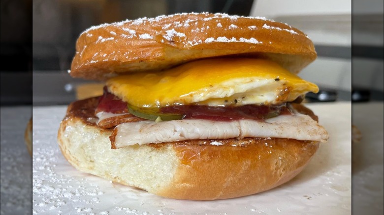 Turkey, jam, fried egg, and cheese on a brioche bun sandwich