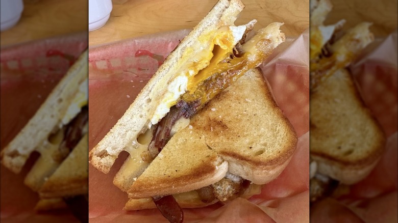 Toasted bread sandwich with egg, cheese, and bacon