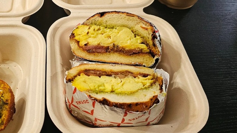 Wrapped and sliced sandwich with eggs and bacon