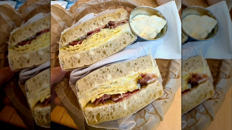 Focaccia sandwich with egg and bacon with a side of aioli
