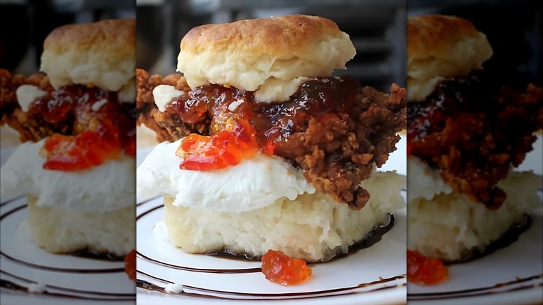 Biscuit sandwich with fried chicken, goat cheese, and pepper jelly
