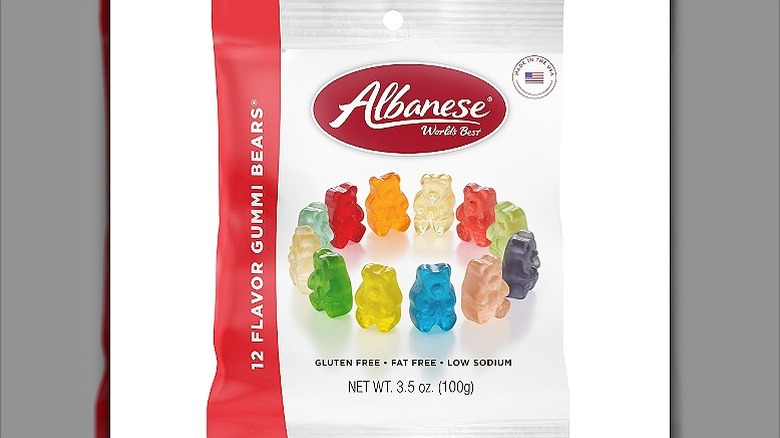 A white and red packet of Albanese 12 flavor gummi bears with a photo of gummi bears on the front