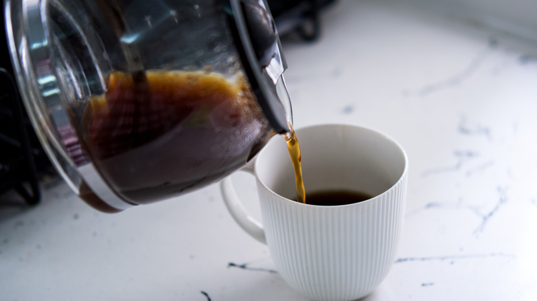 coffee poured from pot into cup