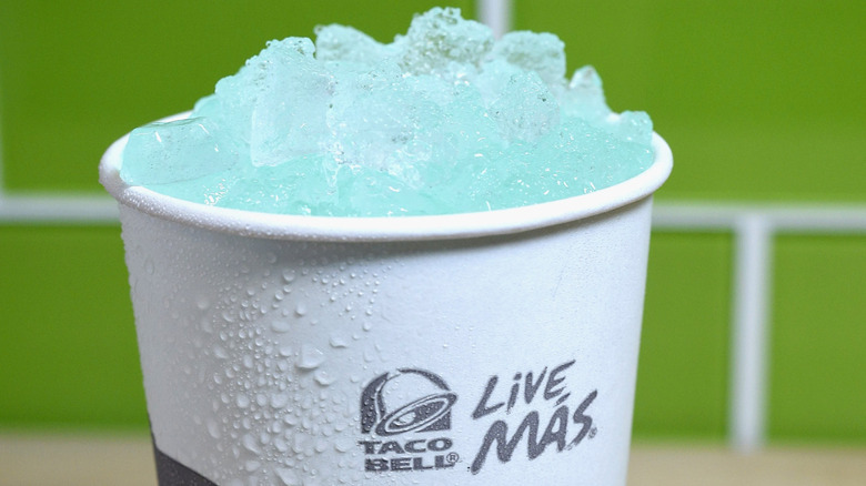 Blue and red soda in a glass with milk poured in