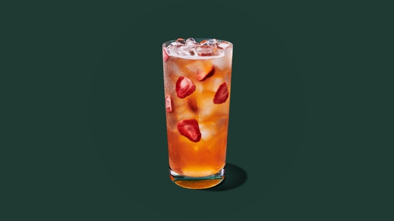 A glass of the Mango Strawberry Refresher with strawberries and ice