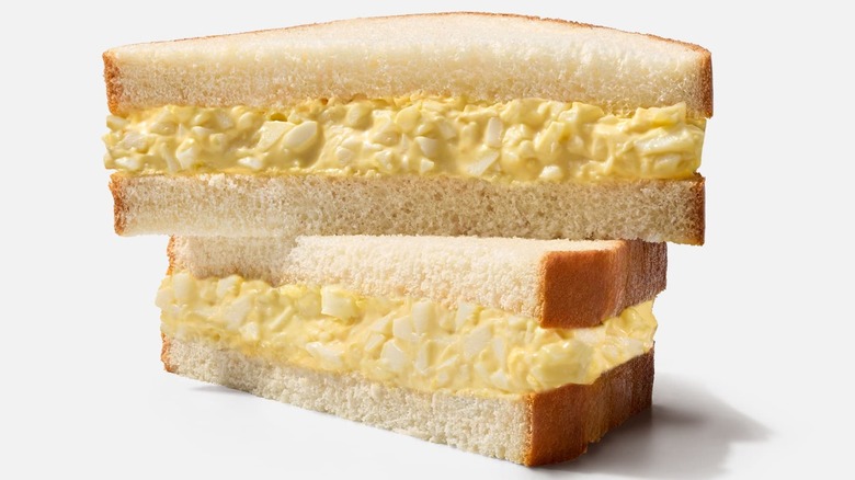 Close up of egg salad sandwich halves stacked on each other