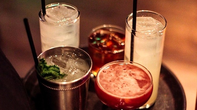 four Sampan happy hour drinks on tray
