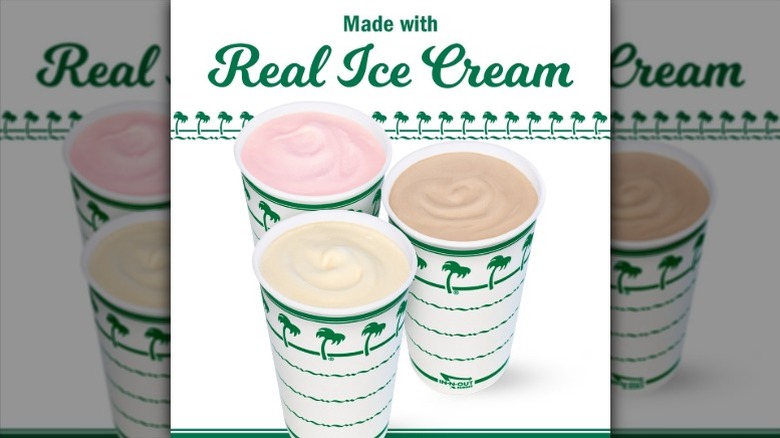 three In-N-Out cups filled with chocolate, vanilla, and strawberry milkshakes.