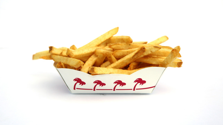 a basket of In-N-Out fries in a branded fry boat against a white background.