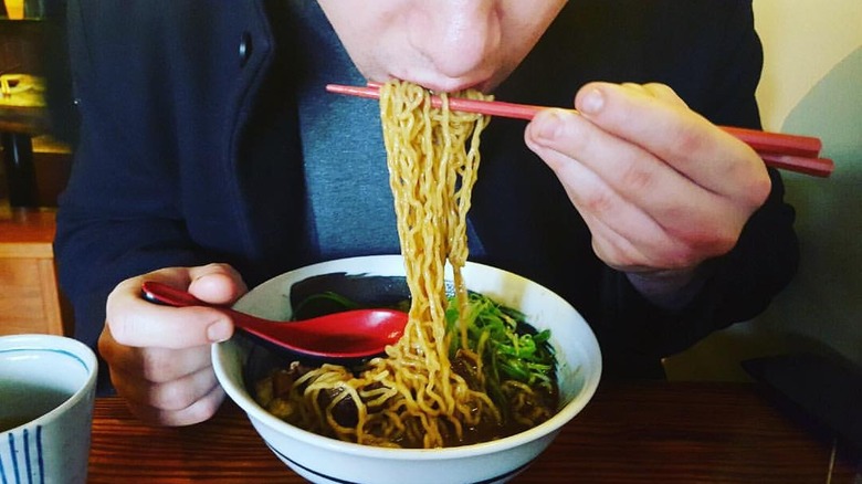 Man slurping noodles at HinoMaru
