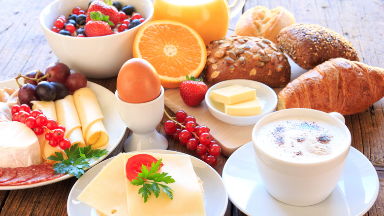 Spread of fruits, cheeses, breads, latte