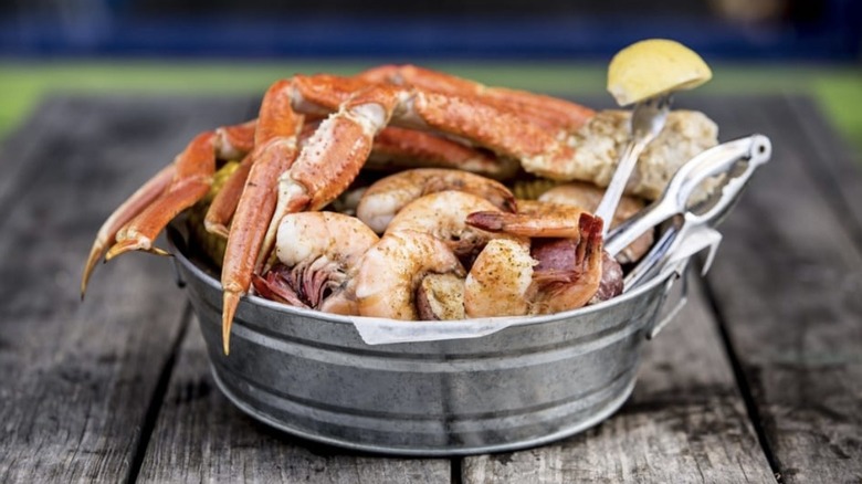 Crab legs inside tin bucket