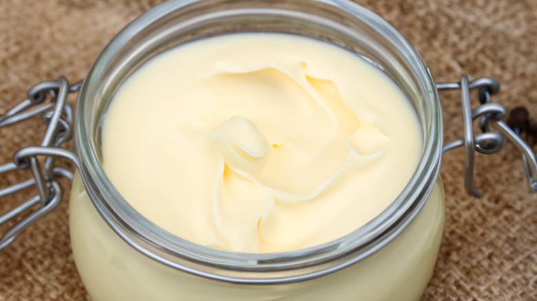 A close-up of a open glass jar of solidified beef tallow
