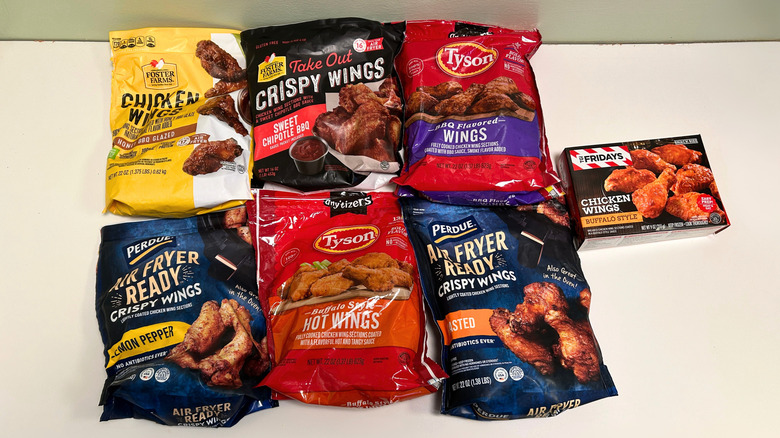 Six bags and one box of different frozen chicken wing brands