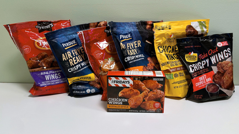 Six bags and one box of different frozen chicken wing brands