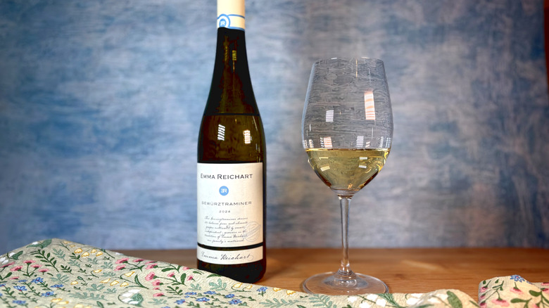 A bottle and glass of gewurztraminer white wine