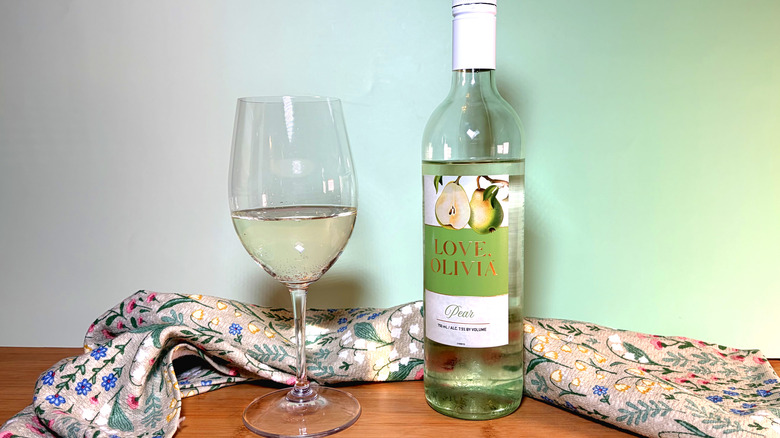 A bottle and glass of pear white wine