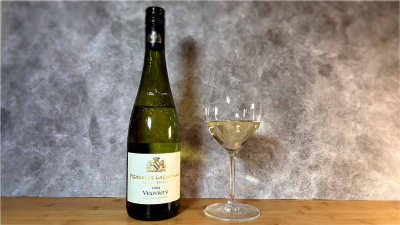 A bottle and glass of vouvray white wine