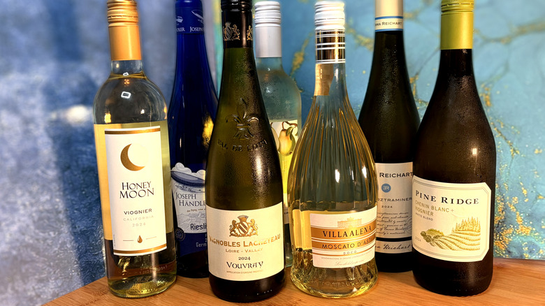 A selection of white wine bottles on table