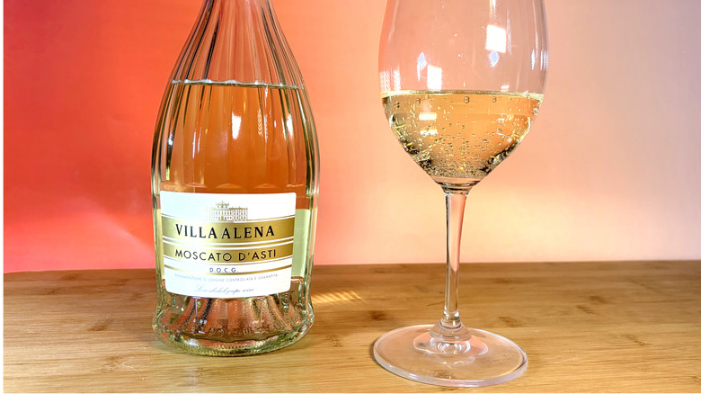 A bottle and glass of moscato wine