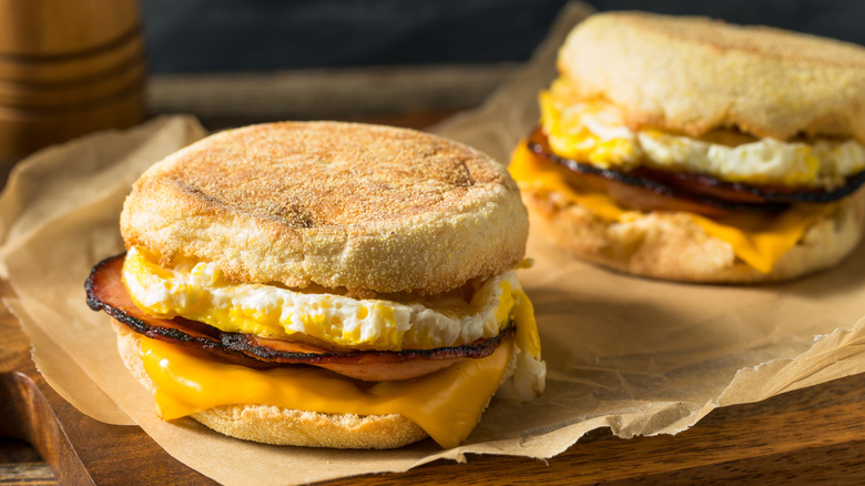 English muffin breakfast sandwiches from a fast food chain on brown paper