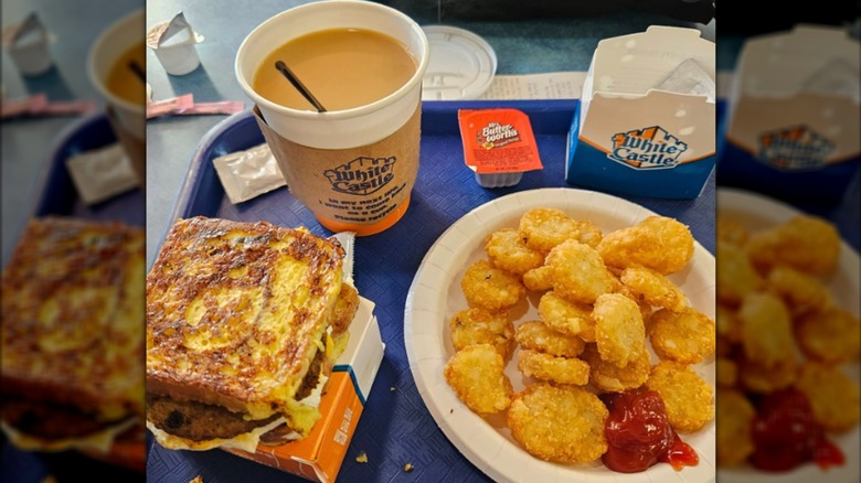 A White Castle French toast breakfast slider with a plate of hashbrowns and a cup of coffee
