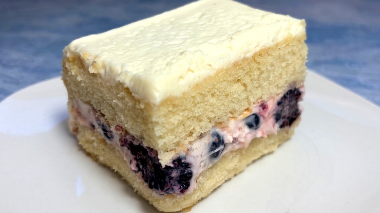 Slice of Whole Foods Berry Chantilly Cake with vanilla cake, berries, and Chantilly frosting
