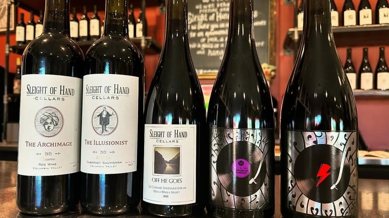 Five bottles of wine on a bar counter