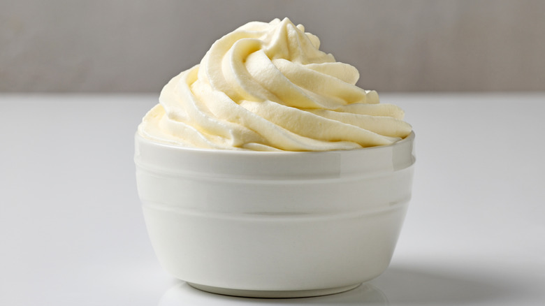A bowl of whipped coconut cream on a table