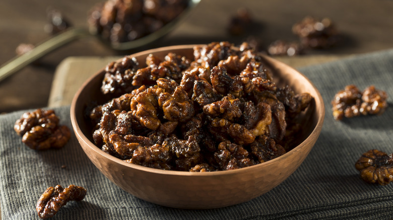 A bowl of candied walnuts on a table