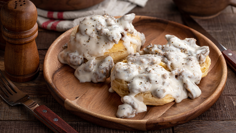 biscuits and gravy on wooden plate