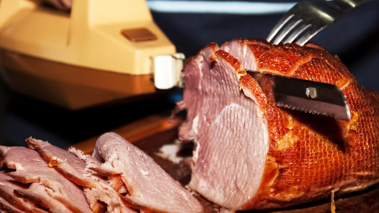 Vintage electric carving knife being used to slice meat