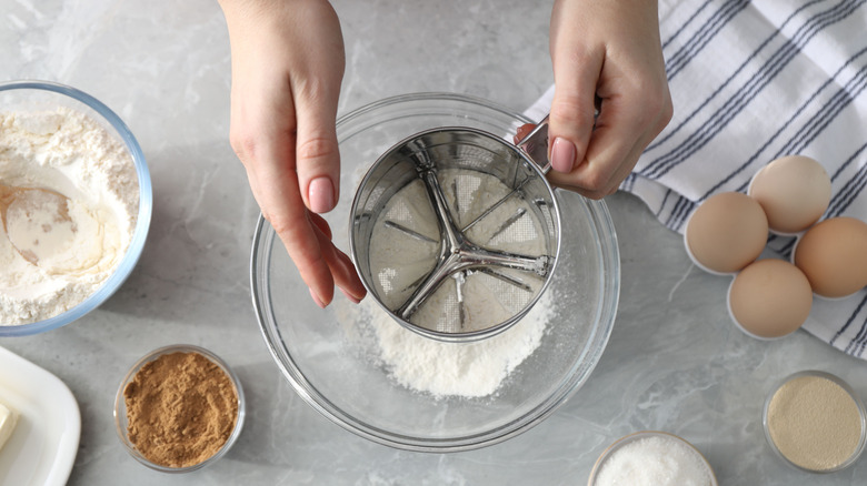 Woman using a flour sifter