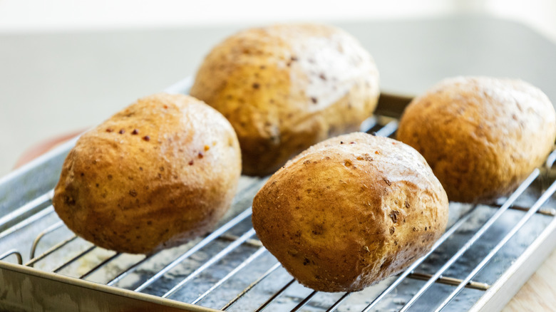 Plain baked potatoes on a rack