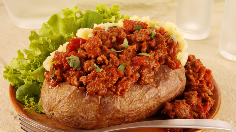 Baked potato with Bolognese sauce on a plate