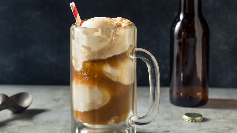 Root beer float with bottle and straw