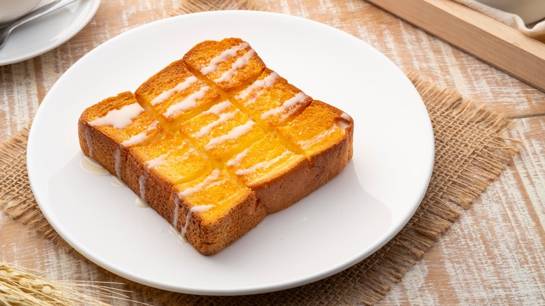 thick toast slice with glaze on white plate