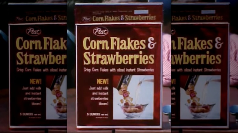 A box of Corn Flakes & Strawberries cereal on an outdoor deck