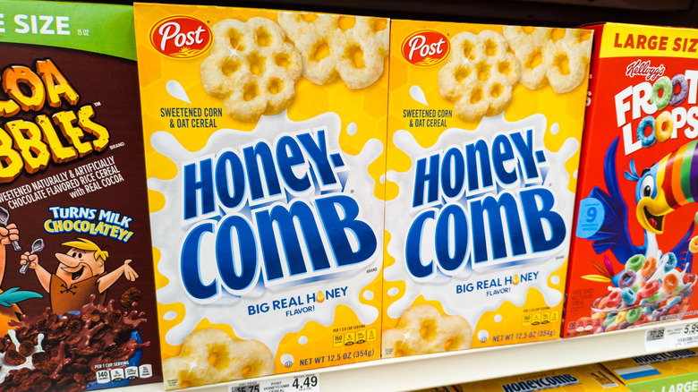 Two boxes of Honeycomb cereal on a store shelf, in-between Cocoa Pebbles and Froot Loops