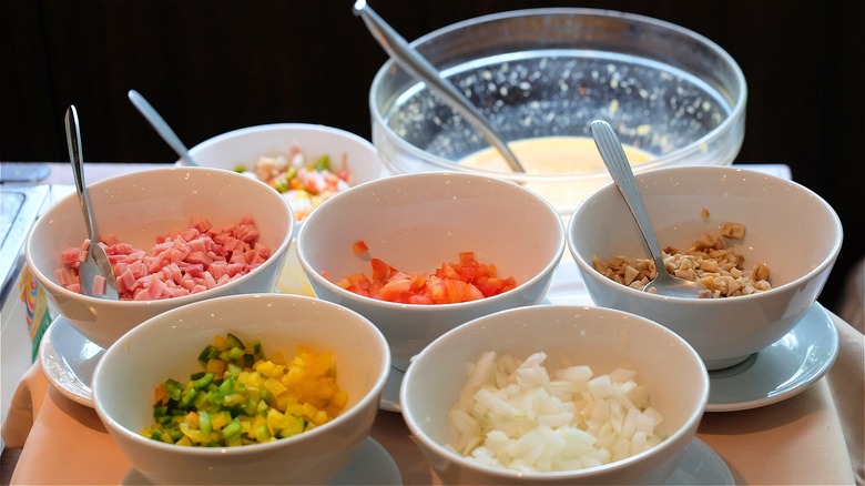 Bowl of eggs and prepared toppings 
