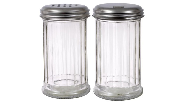 Hand holding glass sugar pourer