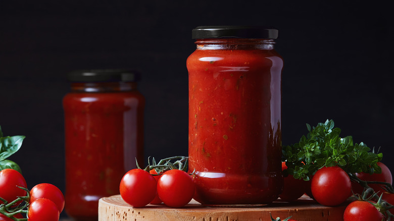 jar of tomato sauce with cherry tomatoes