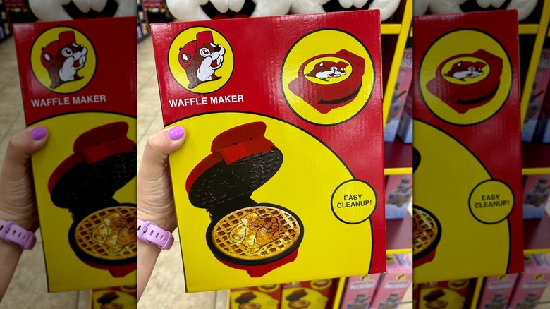 A hand holding a Buc-ee's waffle maker
