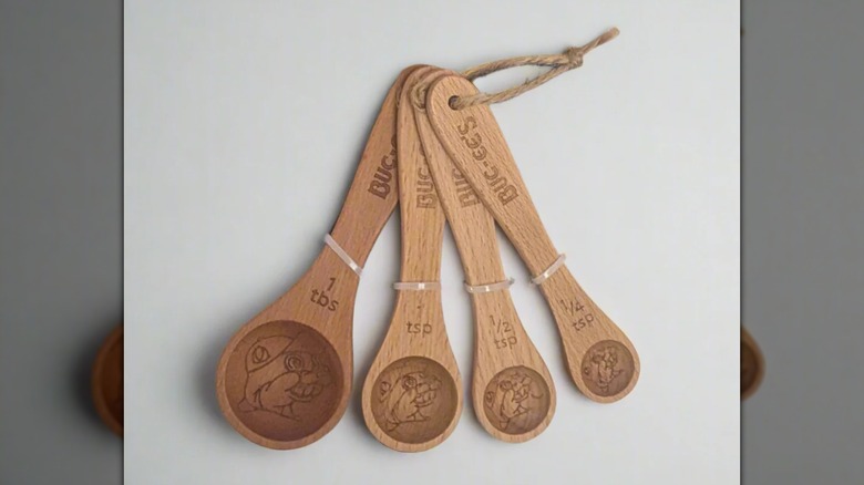Four wooden Buc-ee's measuring spoons on a white background