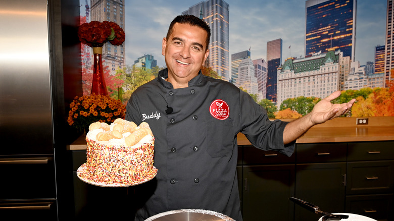 Buddy Valastro posing with cake