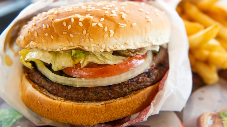 Burger King whopper with fresh onions and tomatoes in wrapper