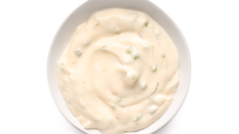 Ramekin of Caesar dressing white background