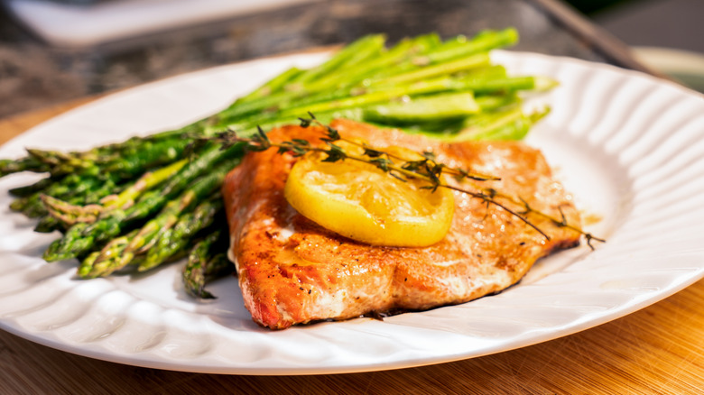Asparagus and salmon on white plate