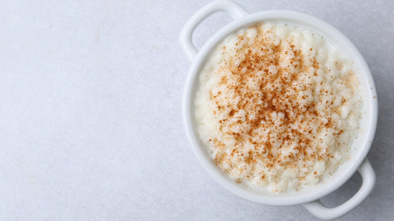 A bowl full of rice pudding on a white table