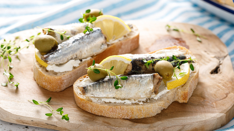 Open sardine sandwiches on a wooden board